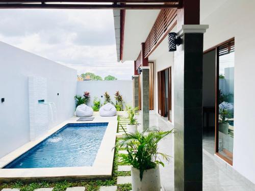 a swimming pool in the backyard of a house at Deon house canggu in Tumbak Bayuh