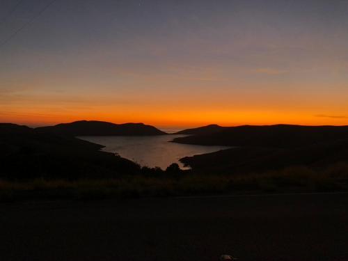 a sunset over a body of water at sunset at Crafty Oak House in Paso Robles