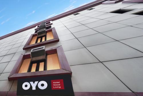 a building with two windows on the side of it at Hotel O Good Living Laxmi Nagar in New Delhi