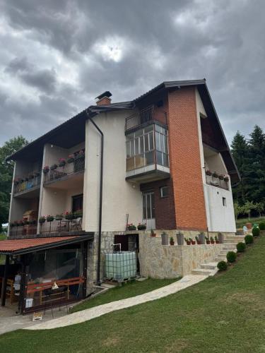 a large brick building with a large window at Vila Trtović in Nova Varoš