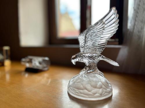 a glass angel vase sitting on a table at Casa Rivendel - Fantasía, Confort y Naturaleza in Poyales del Hoyo
