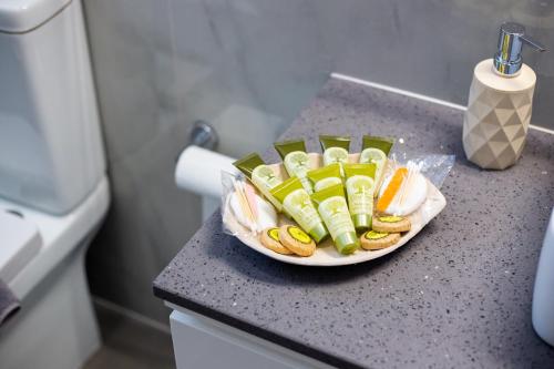 a plate of hot dogs and pickles on a counter at LiRa 2 in Kremasti