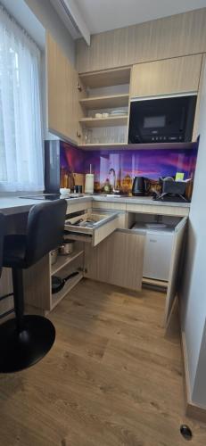 a kitchen with a sink and a counter top at Metropolis Apartamenty Centrum in Kalisz