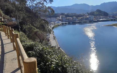 a body of water with a fence next to a beach at Sellamante2 in Ribadesella