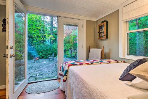 a bedroom with a bed and a large window at The Red Rock Retreat in Chimney Rock