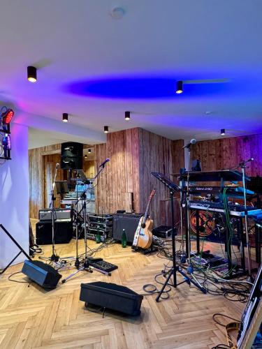 a recording room with a stage and instruments in it at Das Alpl Resort in Krieglach