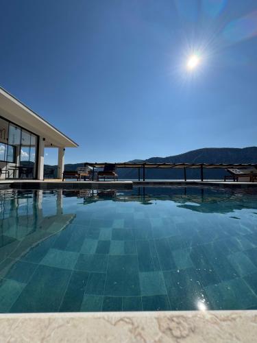 a swimming pool with a view of the ocean at Harmony House - Adults Only in Dubova