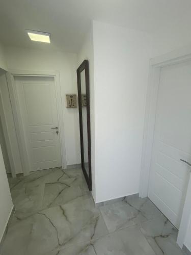 an empty room with a mirror and a door at Villa Mirijana in Zlatna Obala