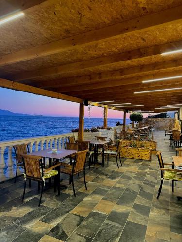 a restaurant on the beach with tables and chairs at Luxury Villa Alisja Sarande with Private Beach in Sarandë