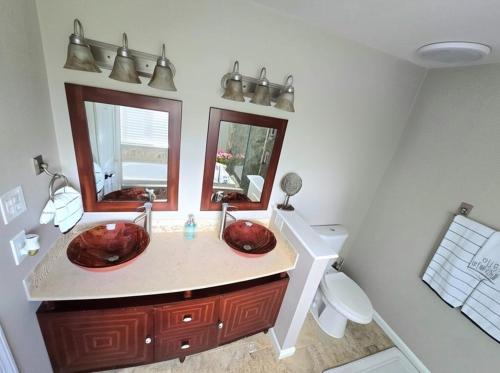 a bathroom with two sinks and a toilet at Loudoun Metro Station Home in Ashburn