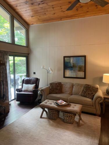 a living room with a couch and a coffee table at Beech Mountain Swiss-style Chalet in Beech Mountain