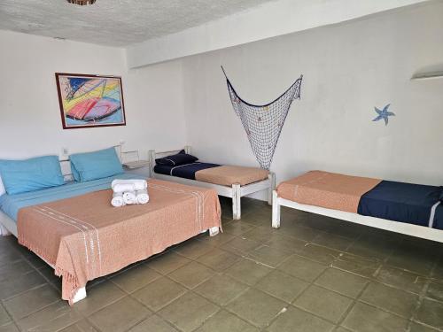 Cama o camas de una habitación en Pousada Canoa do Mar