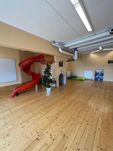a room with a red slide and a christmas tree at Das Alpl Resort in Krieglach