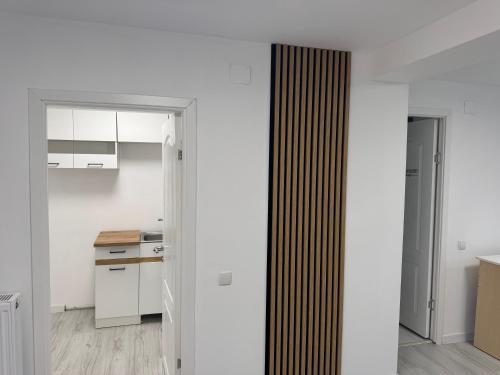 a kitchen with white walls and white cabinets at DS Beauty Center in Drăgăşani