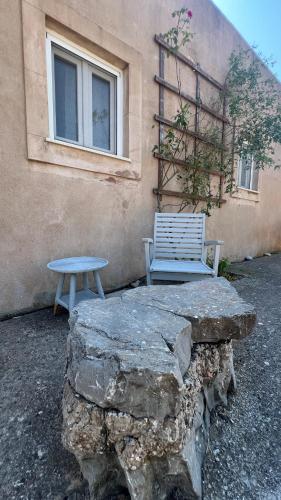 a bench sitting next to a building next to a bench at KYTHIRA ISLAND RETREAT in Áyios Ilías
