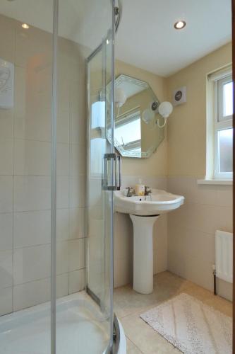 a bathroom with a shower and a sink at Brae-Mar B&B in Portrush