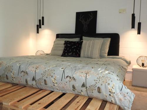 a bedroom with a bed with a wooden floor at Casa Milo in Lokeren