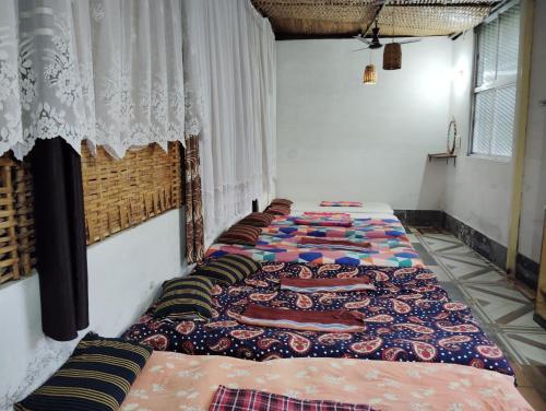 a row of beds sitting in a room at Holiyday in VGF Farm House in Dānishpet
