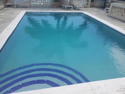 a large swimming pool with blue water at BAYVIEW LUXURY RETREATS st Jame in Montego Bay