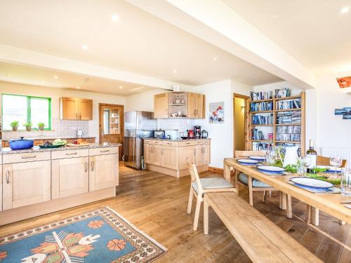a large kitchen with a wooden table and chairs at Longa House in Big Sand