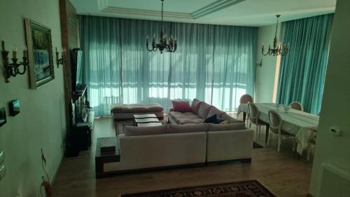 a living room with a couch and a table at Villa Amorino by the Sea in Draçi