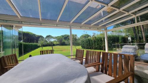a screened in porch with a bed and a large window at Villa Amorino by the Sea in Draçi