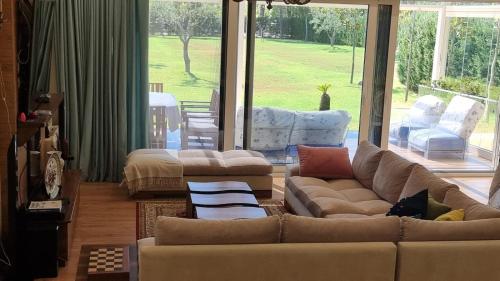 a living room with couches and a large window at Villa Amorino by the Sea in Draçi