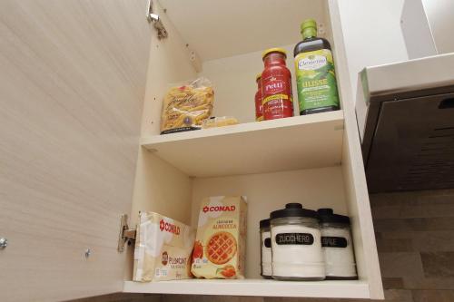 a cabinet with food and drinks in it at Michele Lux Lodge 6 people Spotless and Connected to Airport and Vatican in Rome