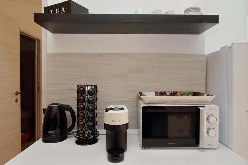 a kitchen with a microwave and a coffee maker at Michele Lux Lodge 6 people Spotless and Connected to Airport and Vatican in Rome