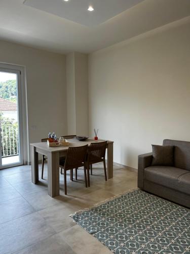 a living room with a table and a couch at San Pietro Pontremoli in Pontremoli