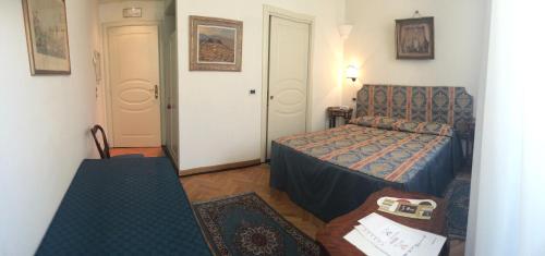 a small room with a bed and a couch at Al Teatro in Livorno