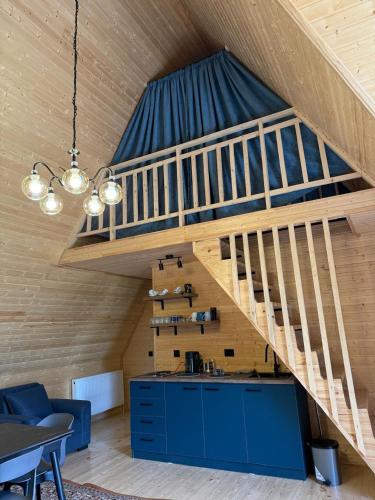 a loft with a staircase in a house at Casa KamArea in Stepantsminda