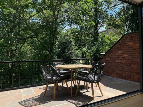 a table and chairs on a balcony with a view of trees at Durham City Centre Hideaway - Terrace with View & Parking in Durham