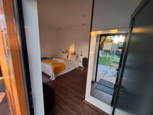 a bedroom with a bed and a sliding glass door at Quinta Salinas - Puro Prazer in Aveiro