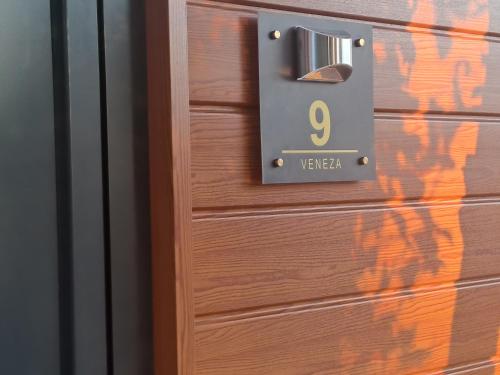 a wooden door with the number on it at Quinta Salinas - Puro Prazer in Aveiro