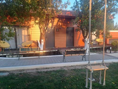a group of benches in front of a house at Quinta Salinas - Puro Prazer in Aveiro