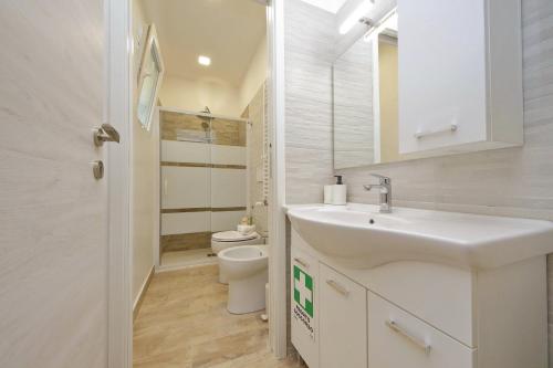 a white bathroom with a sink and a toilet at Michele Lux Lodge 6 people Spotless and Connected to Airport and Vatican in Rome