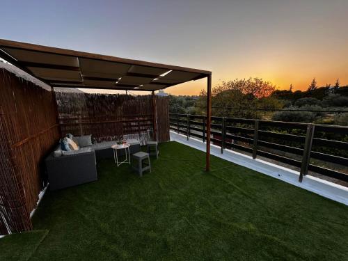 a patio with a table and chairs on a deck at Charavgi House in Archangelos