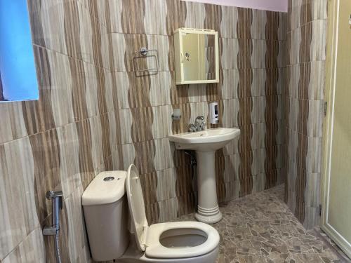 a bathroom with a toilet and a sink at ZnZ Homestay in Shillong