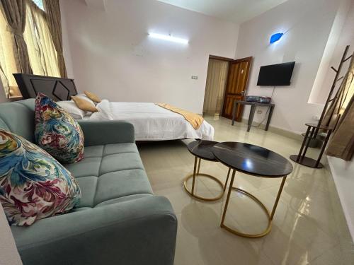 a living room with a couch and a bed at ZnZ Homestay in Shillong