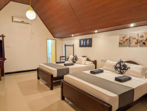 a bedroom with two beds in a room at Sigiri Choona Lodge 'unique sunrise viewpoint' in Sigiriya