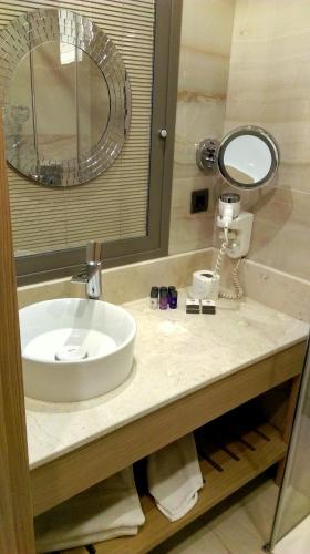 a bathroom counter with a sink and a mirror at Lale Hotel in Sapanca
