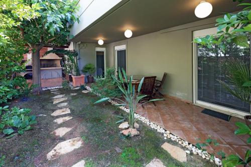 a patio of a house with a table and chairs at Rafina Splendor in Rafina