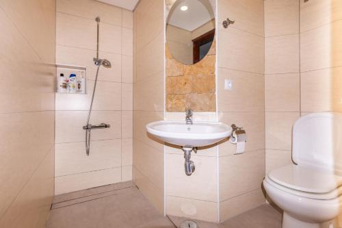a bathroom with a toilet and a sink and a shower at Carpe Diem in Faro