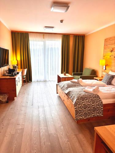a hotel room with a bed and a desk at Das Alpl Resort in Krieglach
