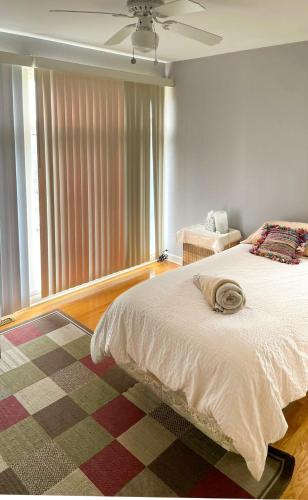 a bedroom with a bed and a ceiling fan at Top of the Hill, Meadowbrook in Syracuse
