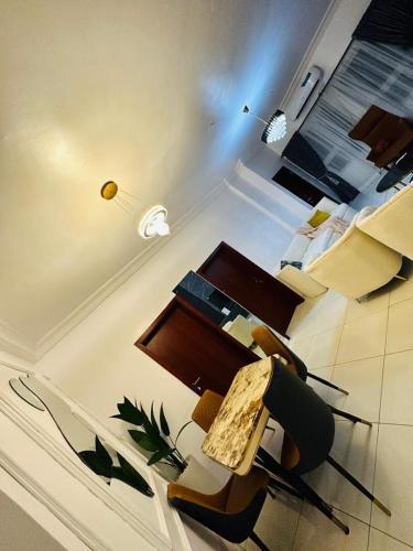 a living room with a table and chairs in a room at Emerald luxe with constant power in Lagos