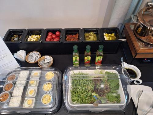 two trays of food on a table with other foods at Hotel Aviator in Kamień Śląski