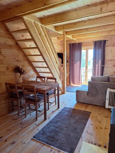 a living room with a table and a couch at Chalets Montenegrina in Žabljak