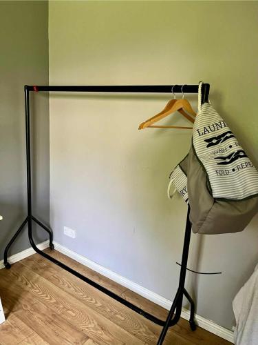 a room with a white wall with at Private Room Near Airport, The Rabbit & Hilton Templepatrick Ideal for Spa, Weddings & Stopovers in Templepatrick